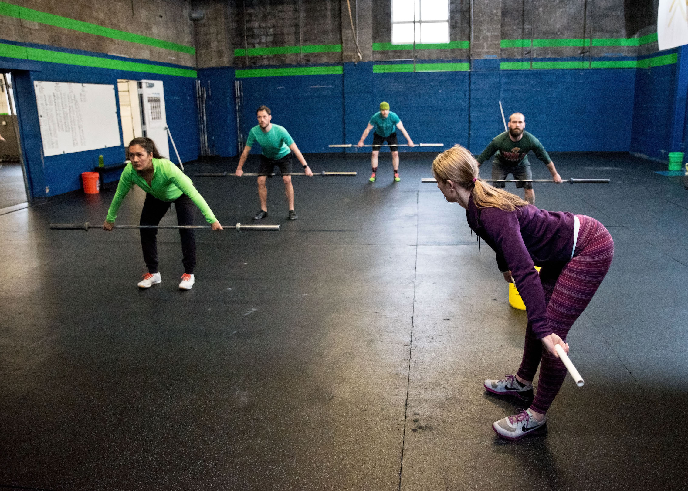 Coach leads a class through deadlift mechanics