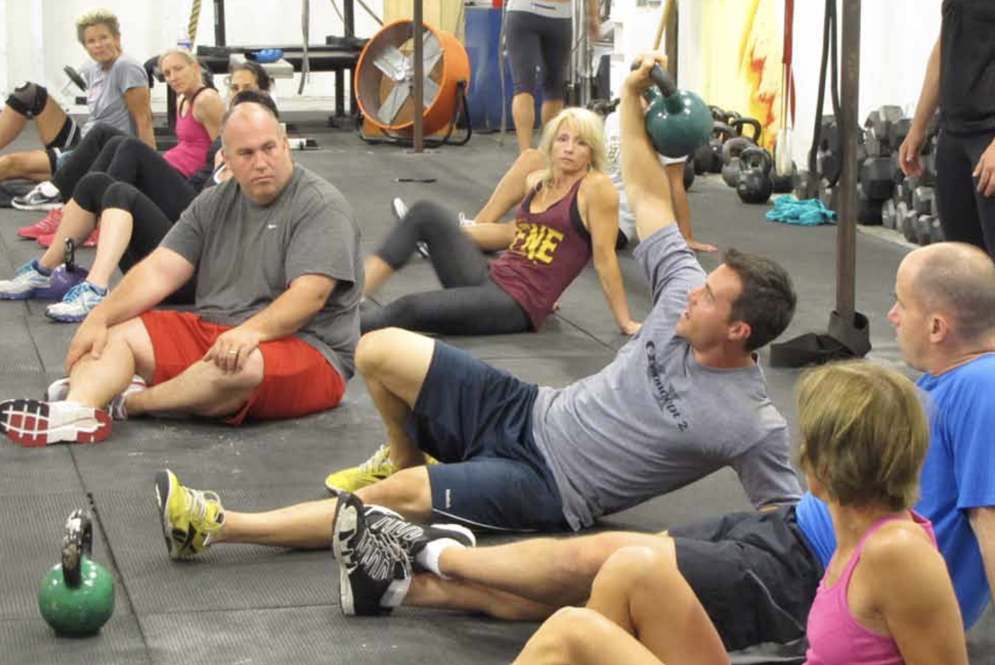 Ben Bergeron demonstrates the Turkish get-up during a CrossFit class.